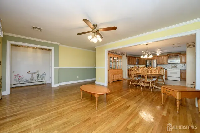 a view of a dining room with furniture and wooden floor