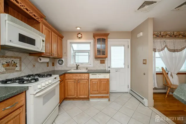 a kitchen with a stove a sink and a refrigerator