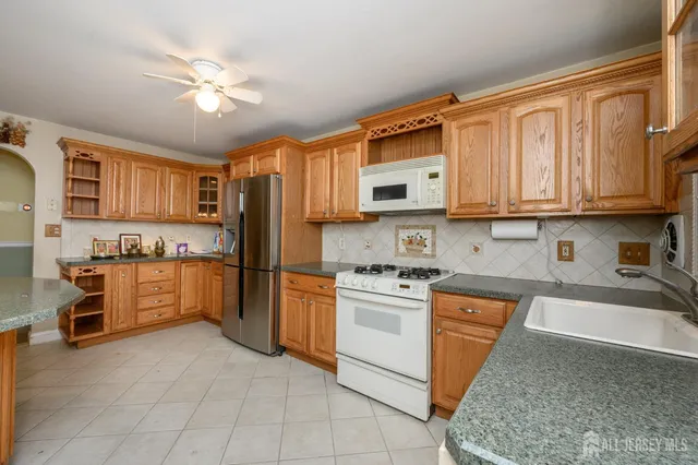 a kitchen with stainless steel appliances granite countertop a refrigerator sink and cabinets