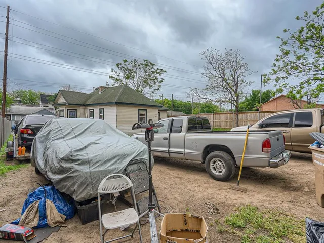 a view of backyard with parked car