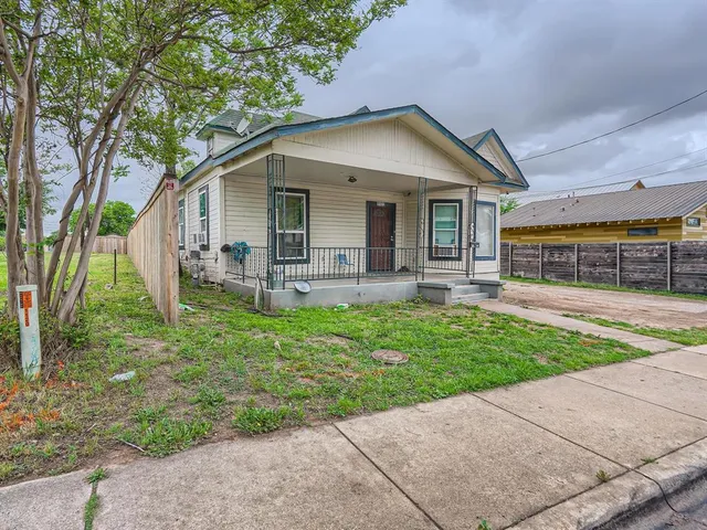a front view of house with yard and outdoor seating
