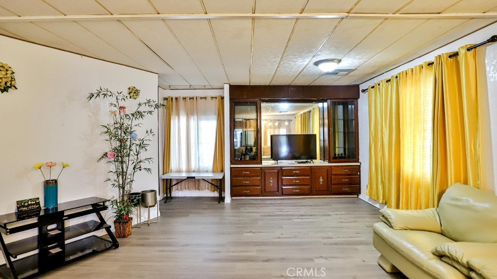 14300 Clinton Street, Unit 64 Garden Grove, CA 92843 - Photo 13 of 48 a large living room with furniture and large windows