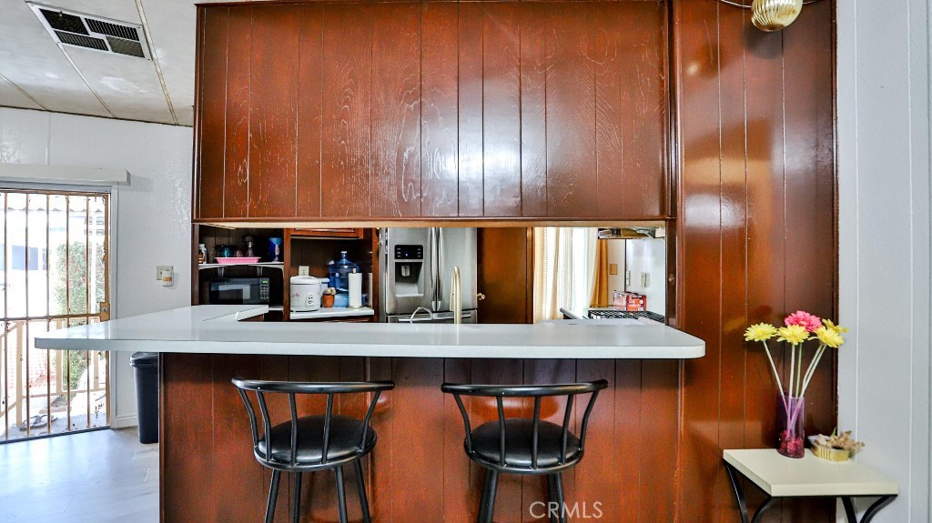 14300 Clinton Street, Unit 64 Garden Grove, CA 92843 - Photo 18 of 48 a dining room with furniture and wooden floor