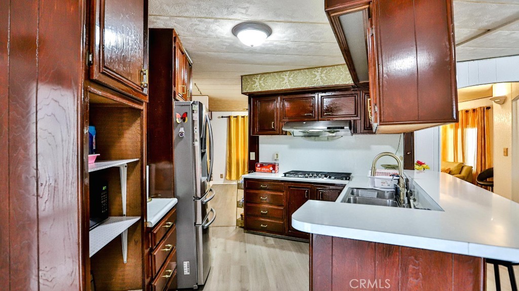14300 Clinton Street, Unit 64 Garden Grove, CA 92843 - Photo 21 of 48 a kitchen with counter top space cabinets and stainless steel appliances