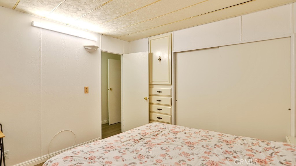14300 Clinton Street, Unit 64 Garden Grove, CA 92843 - Photo 31 of 48 a bedroom with a bed and a dresser