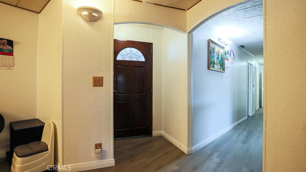 14300 Clinton Street, Unit 64 Garden Grove, CA 92843 - Photo 41 of 48 a view of a hallway with wooden floor and glass door