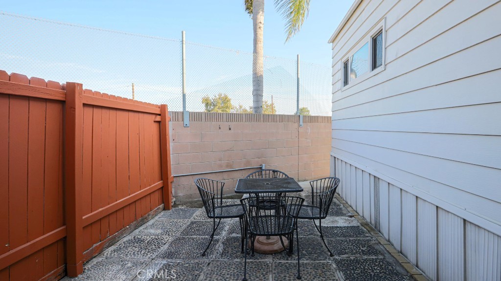 14300 Clinton Street, Unit 64 Garden Grove, CA 92843 - Photo 43 of 48 a view of a patio with table and chairs