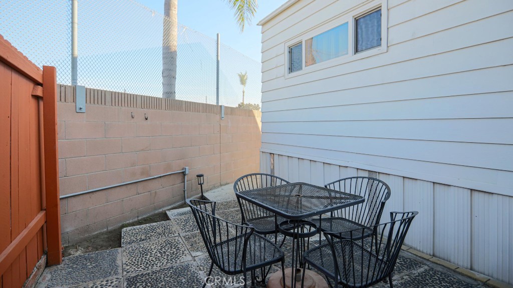 14300 Clinton Street, Unit 64 Garden Grove, CA 92843 - Photo 44 of 48 a view of a patio with table and chairs and potted plants