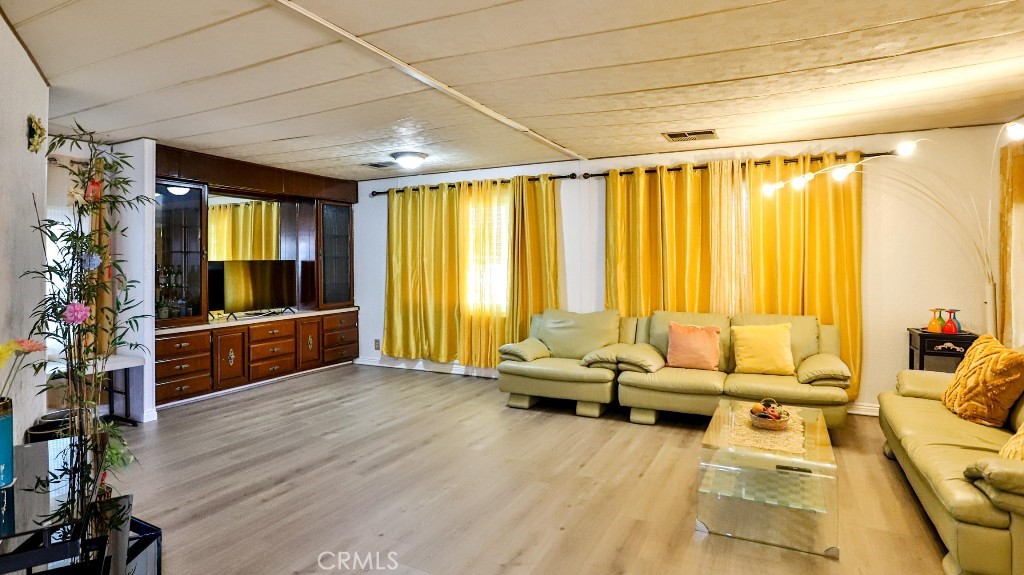 14300 Clinton Street, Unit 64 Garden Grove, CA 92843 - Photo 8 of 48 a living room with furniture and a flat screen tv