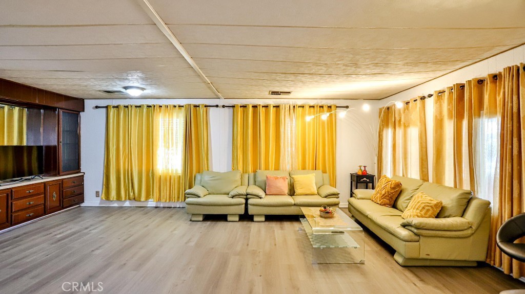 14300 Clinton Street, Unit 64 Garden Grove, CA 92843 - Photo 9 of 48 a living room with furniture and a flat screen tv