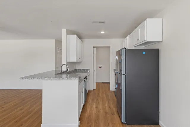 a view of a room with wooden floor