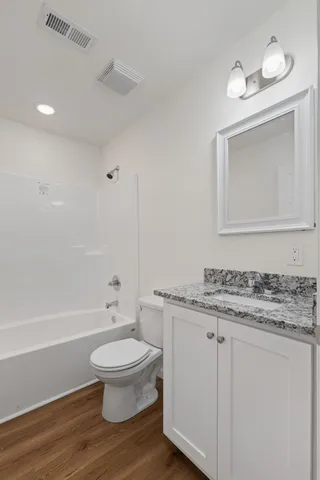 an empty room with a window and a ceiling fan