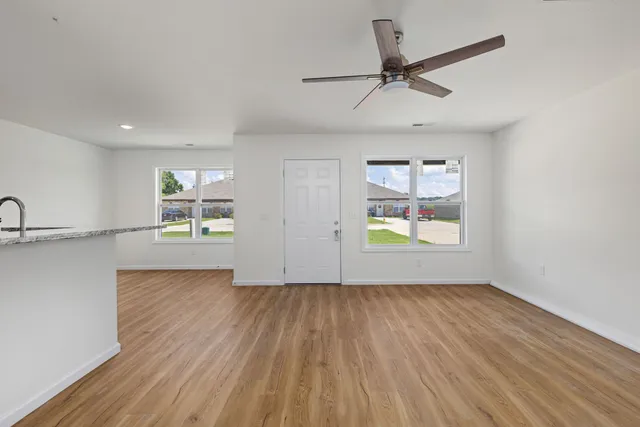 a view of a kitchen with wooden floor and a sink
