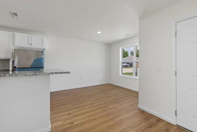 a kitchen with stainless steel appliances granite countertop a stove top oven microwave and cabinets