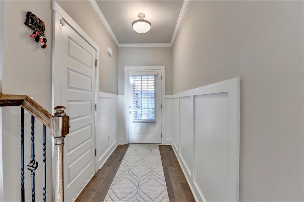 a view of a hallway with wooden floor and staircase
