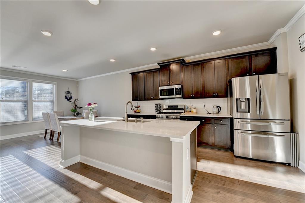 2230 Manor Pointe Drive Cumming, GA 30041 - Photo 14 of 53 a kitchen with stainless steel appliances a refrigerator sink and microwave