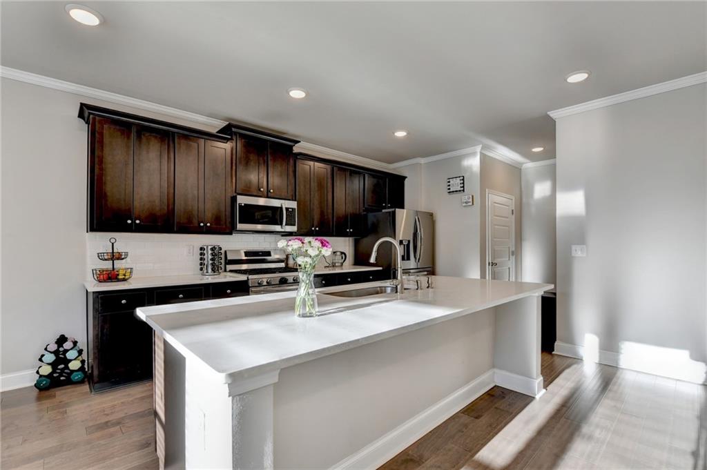 2230 Manor Pointe Drive Cumming, GA 30041 - Photo 16 of 53 a kitchen with stainless steel appliances granite countertop a sink refrigerator and microwave