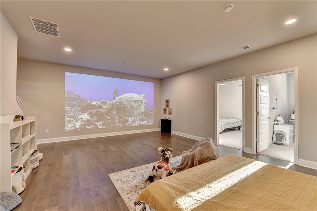 2230 Manor Pointe Drive Cumming, GA 30041 - Photo 19 of 53 a bedroom with a bed and a flat screen tv