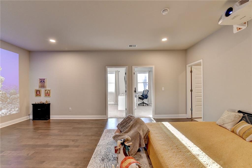 2230 Manor Pointe Drive Cumming, GA 30041 - Photo 20 of 53 a spacious bedroom with a bed and a large window