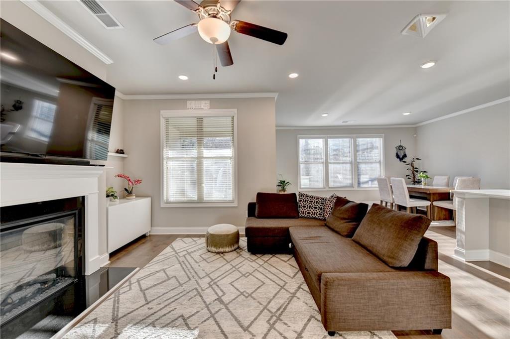 2230 Manor Pointe Drive Cumming, GA 30041 - Photo 2 of 53 a living room with furniture a fireplace and a flat screen tv