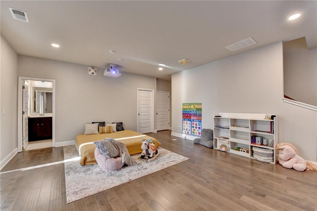 2230 Manor Pointe Drive Cumming, GA 30041 - Photo 22 of 53 a bedroom with furniture and a wooden floor