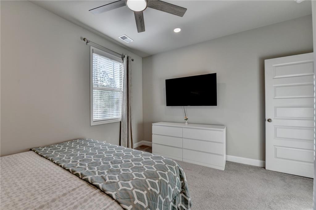 2230 Manor Pointe Drive Cumming, GA 30041 - Photo 28 of 53 a bedroom with a bed and a flat screen tv