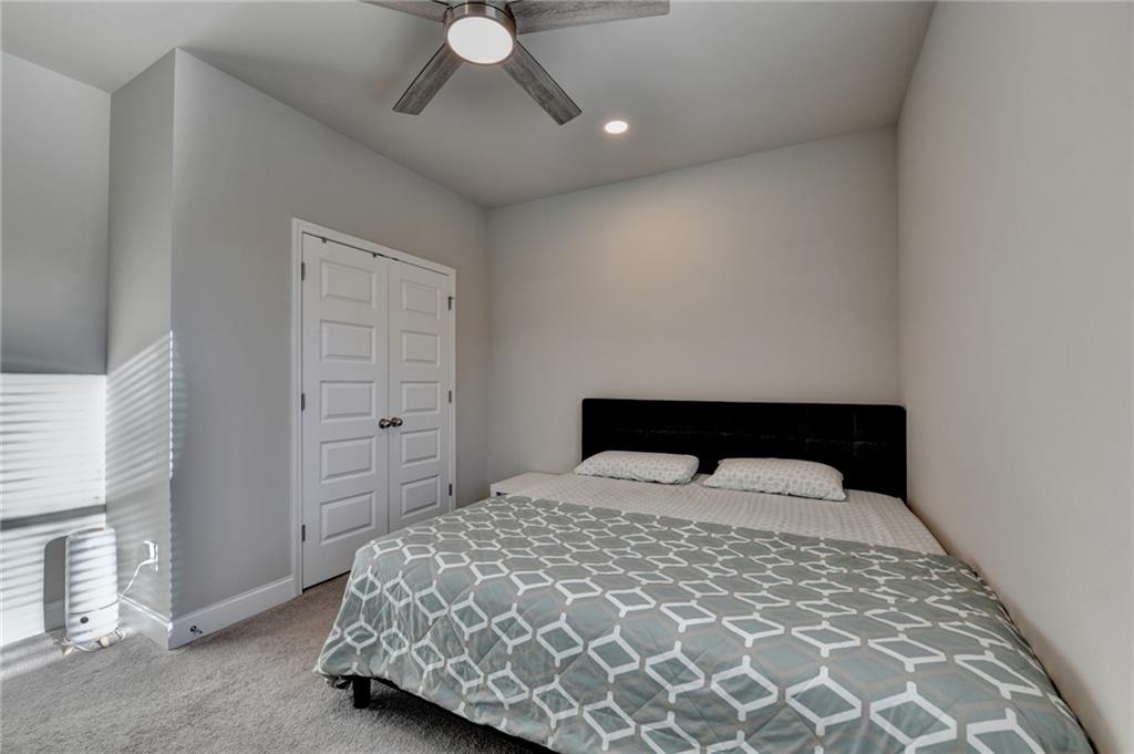 2230 Manor Pointe Drive Cumming, GA 30041 - Photo 29 of 53 a bedroom with a bed and a chandelier