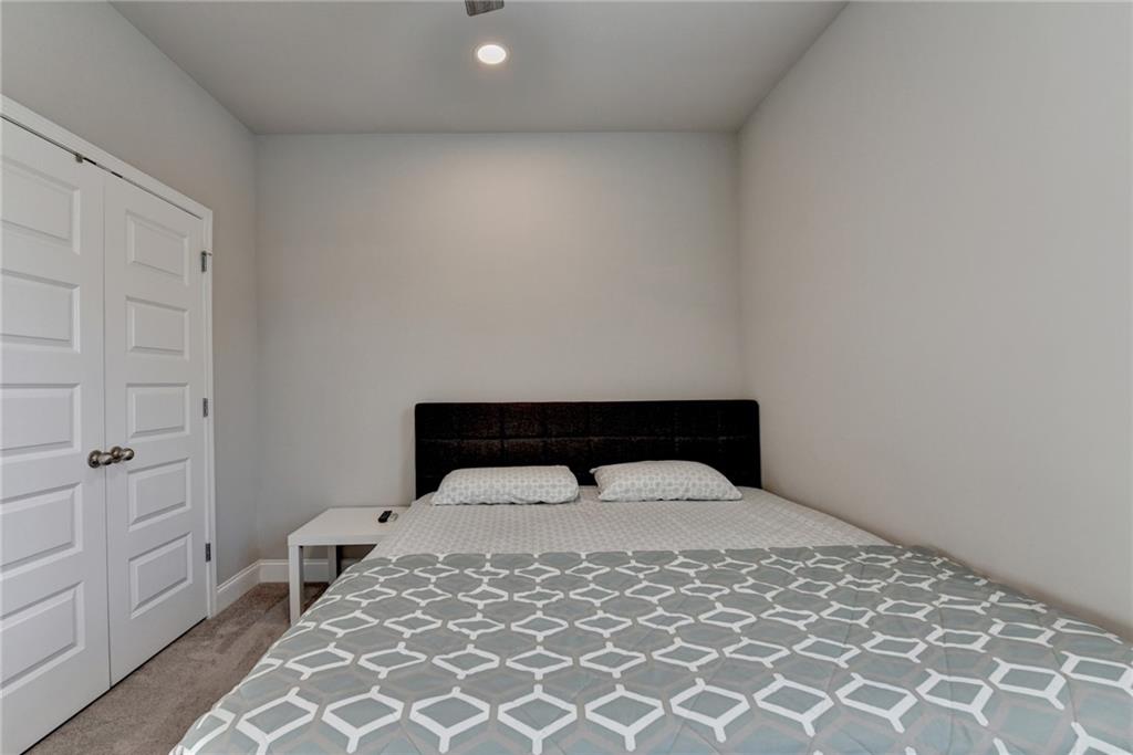 2230 Manor Pointe Drive Cumming, GA 30041 - Photo 30 of 53 a bed sitting in a bedroom next to a window