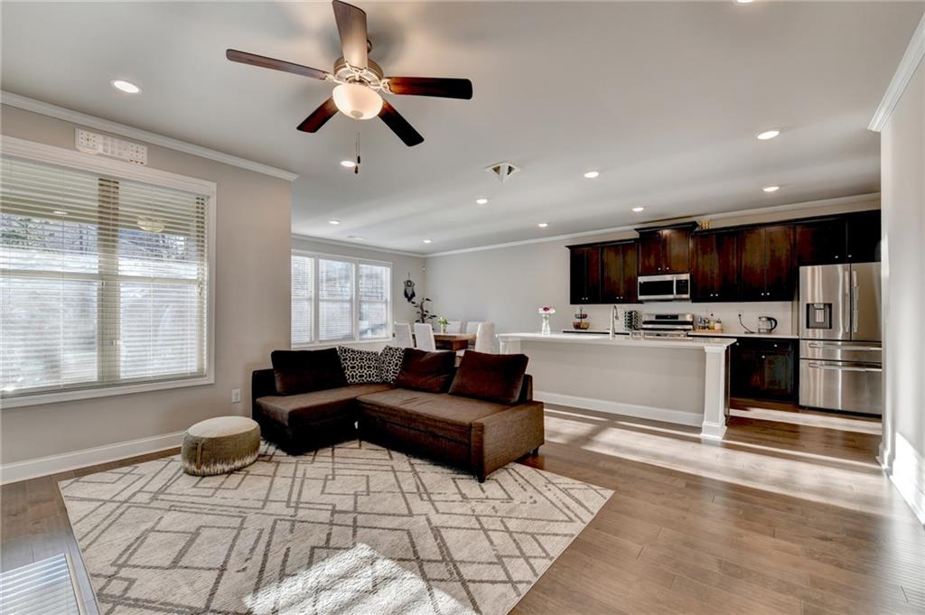 2230 Manor Pointe Drive Cumming, GA 30041 - Photo 3 of 53 a living room with stainless steel appliances kitchen island granite countertop a stove and a sink