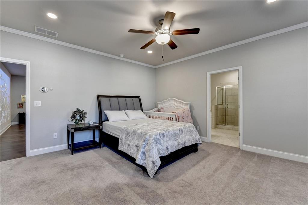 2230 Manor Pointe Drive Cumming, GA 30041 - Photo 32 of 53 a bedroom with a bed and a ceiling fan
