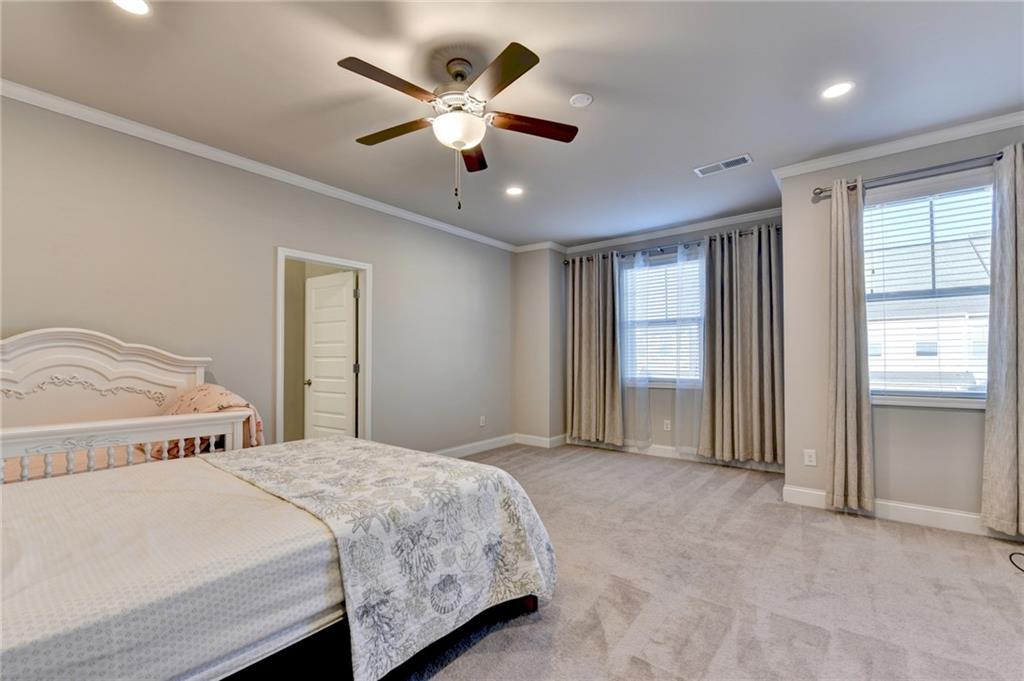 2230 Manor Pointe Drive Cumming, GA 30041 - Photo 34 of 53 a spacious bedroom with a large bed and a chandelier