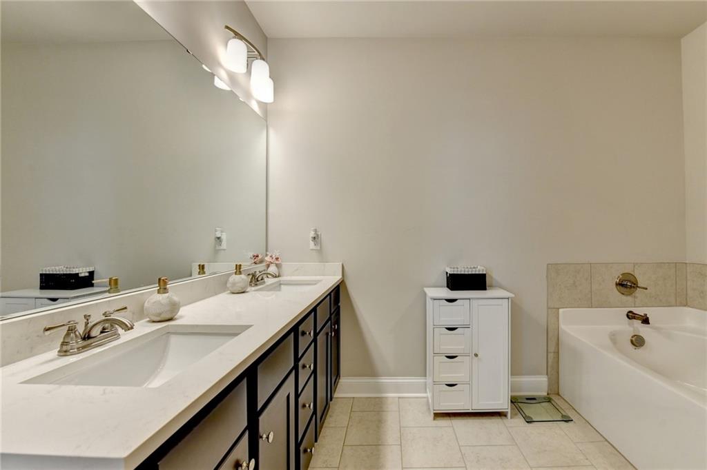 2230 Manor Pointe Drive Cumming, GA 30041 - Photo 35 of 53 a bathroom with a tub sink and mirror