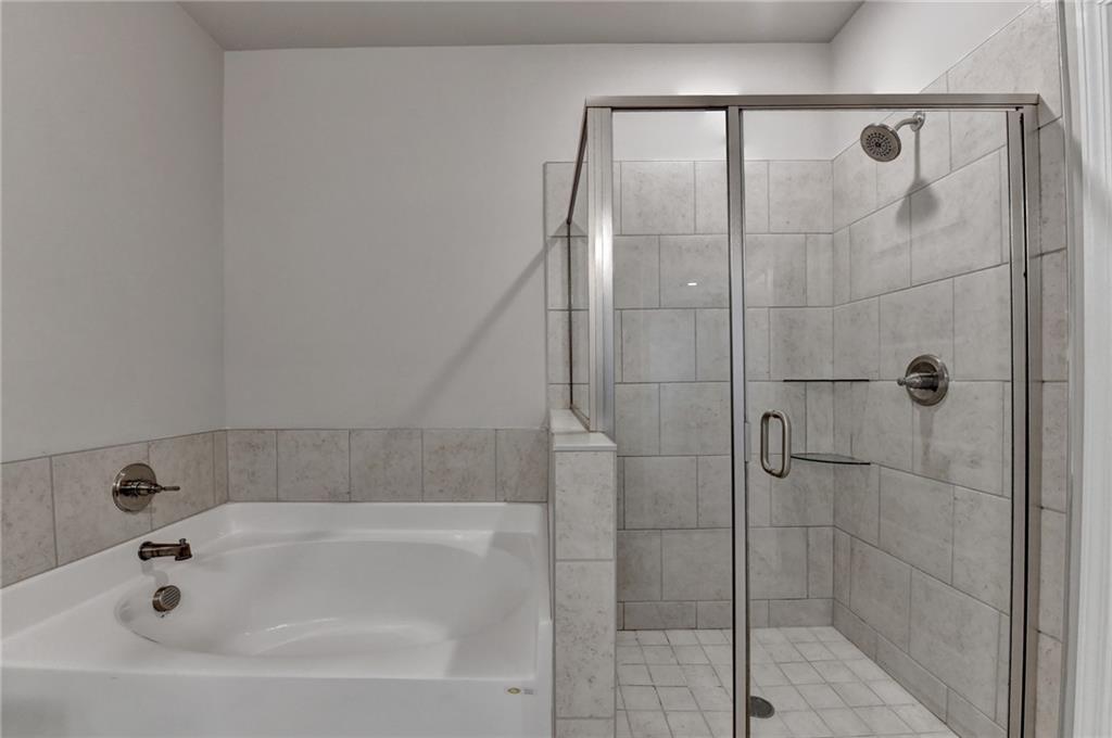 2230 Manor Pointe Drive Cumming, GA 30041 - Photo 36 of 53 a bathroom with a bathtub