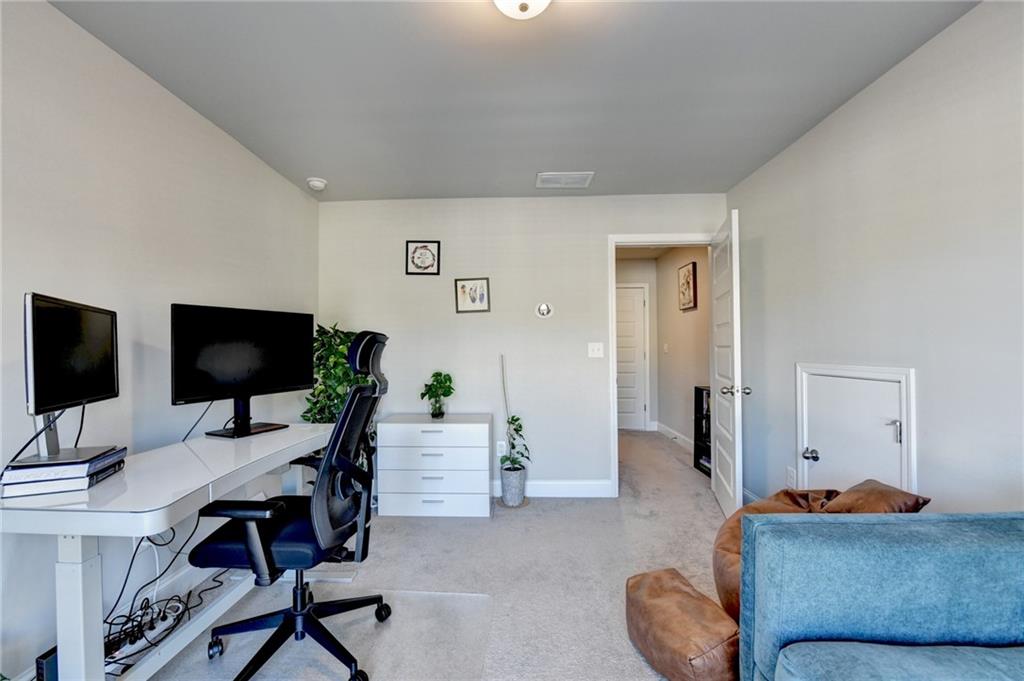 2230 Manor Pointe Drive Cumming, GA 30041 - Photo 39 of 53 a living room with furniture and a flat screen tv