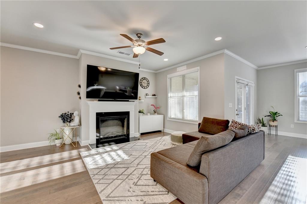 2230 Manor Pointe Drive Cumming, GA 30041 - Photo 4 of 53 a living room with furniture a fireplace and a flat screen tv