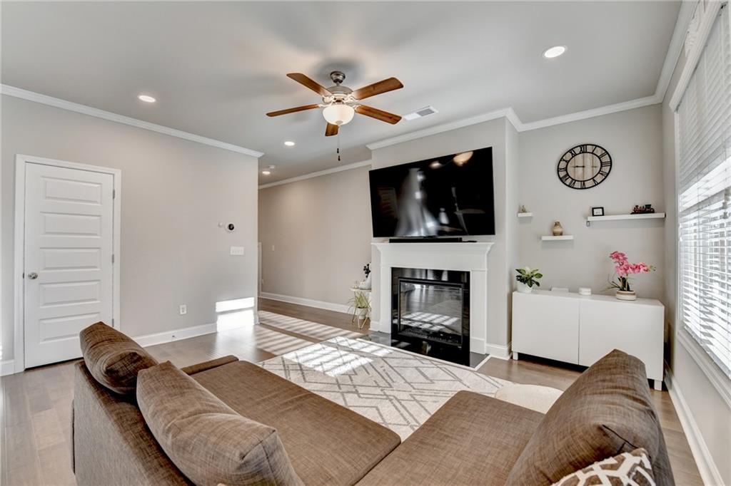 2230 Manor Pointe Drive Cumming, GA 30041 - Photo 6 of 53 a living room with furniture a flat screen tv and a fireplace