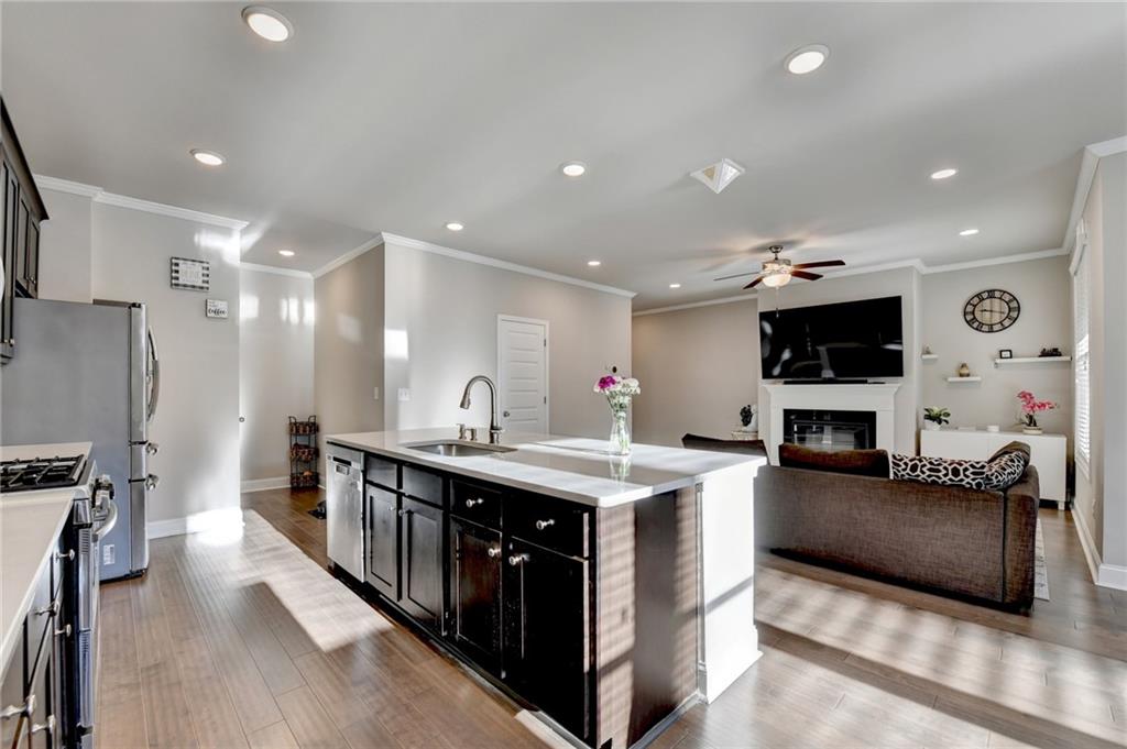 2230 Manor Pointe Drive Cumming, GA 30041 - Photo 10 of 53 a large kitchen with stainless steel appliances a stove and a large kitchen island