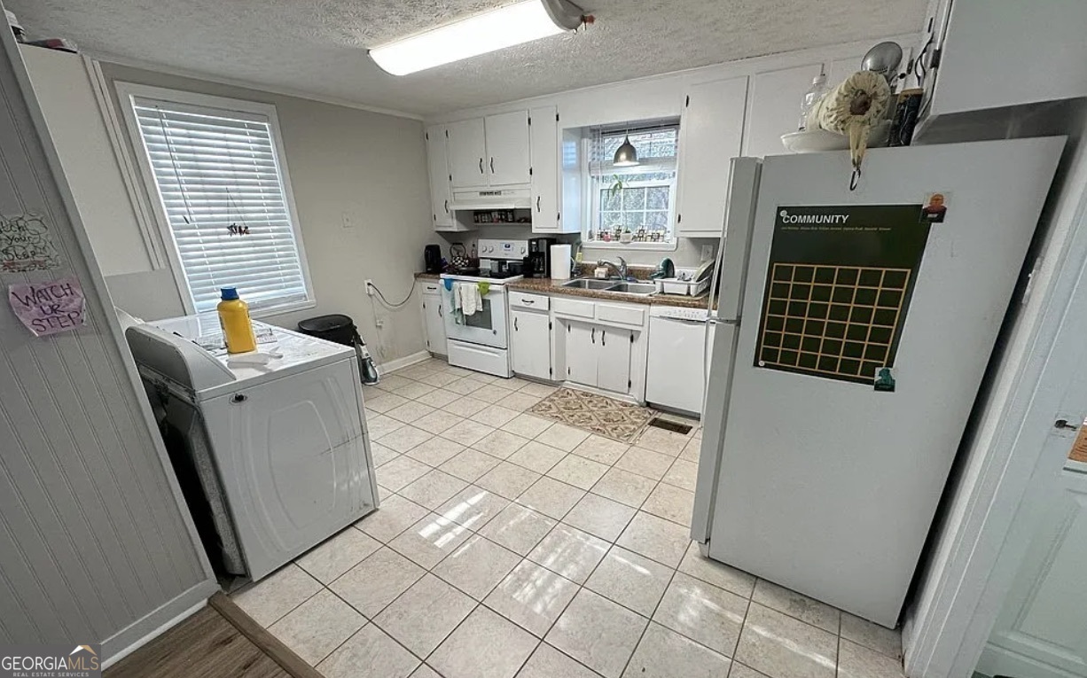 1734 East Broad Street Athens, GA 30601 - Photo 5 of 15 a kitchen with sink cabinets and window