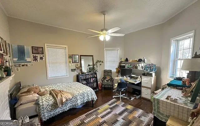 a bedroom with bed a chair and a chandelier