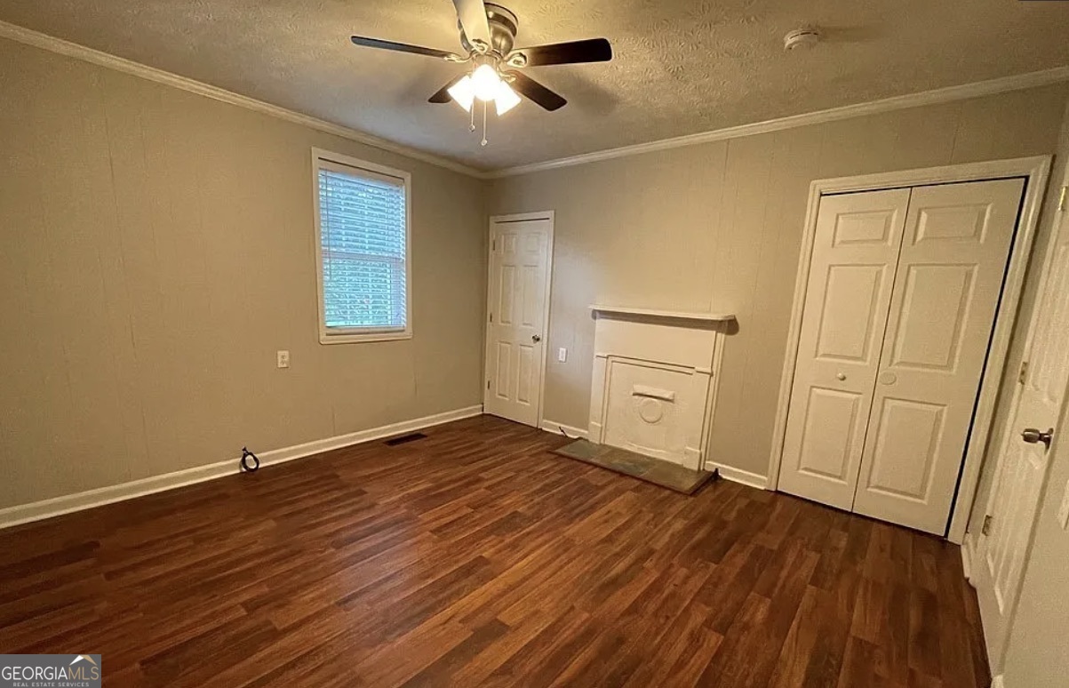 1734 East Broad Street Athens, GA 30601 - Photo 7 of 15 a view of an empty room with wooden floor and a window
