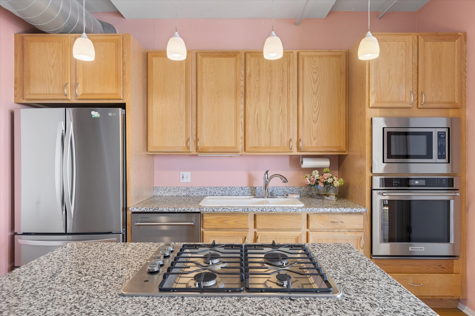 1530 South State Street, Unit 17R Chicago, IL 60605 - Photo 11 of 44 a kitchen with stainless steel appliances granite countertop a stove a sink and a microwave