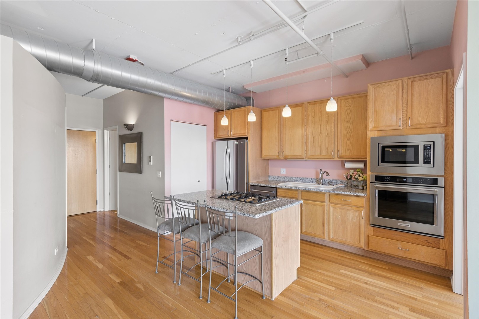 1530 South State Street, Unit 17R Chicago, IL 60605 - Photo 12 of 44 a kitchen with stainless steel appliances granite countertop a stove cabinets and wooden floor
