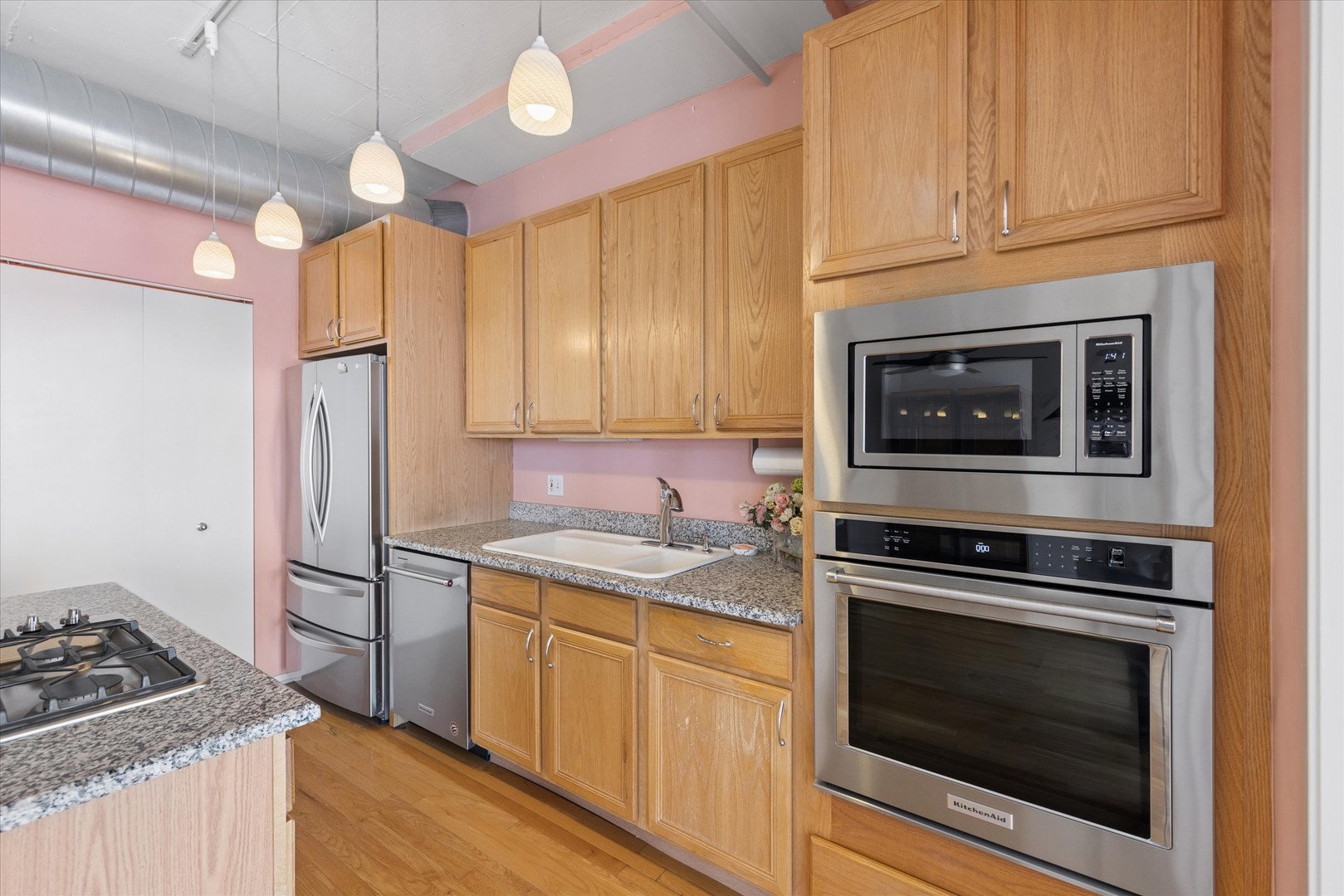 1530 South State Street, Unit 17R Chicago, IL 60605 - Photo 13 of 44 a kitchen with stainless steel appliances granite countertop a stove microwave and refrigerator