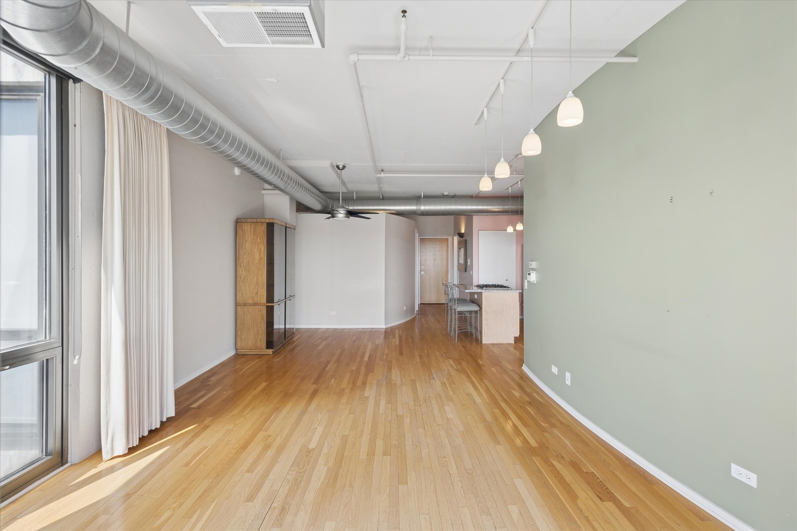 1530 South State Street, Unit 17R Chicago, IL 60605 - Photo 20 of 44 a view of a room with wooden floor and a ceiling fan