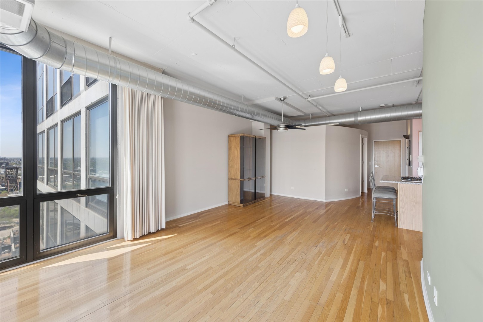 1530 South State Street, Unit 17R Chicago, IL 60605 - Photo 21 of 44 a view of empty room with wooden floor and fan