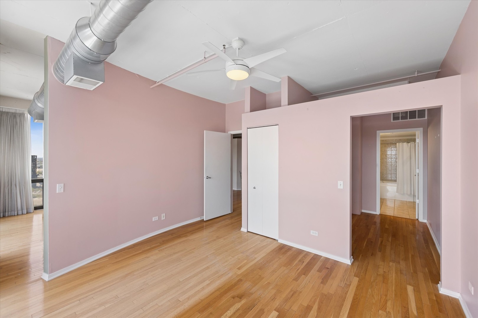 1530 South State Street, Unit 17R Chicago, IL 60605 - Photo 23 of 44 a view of an empty room with wooden floor