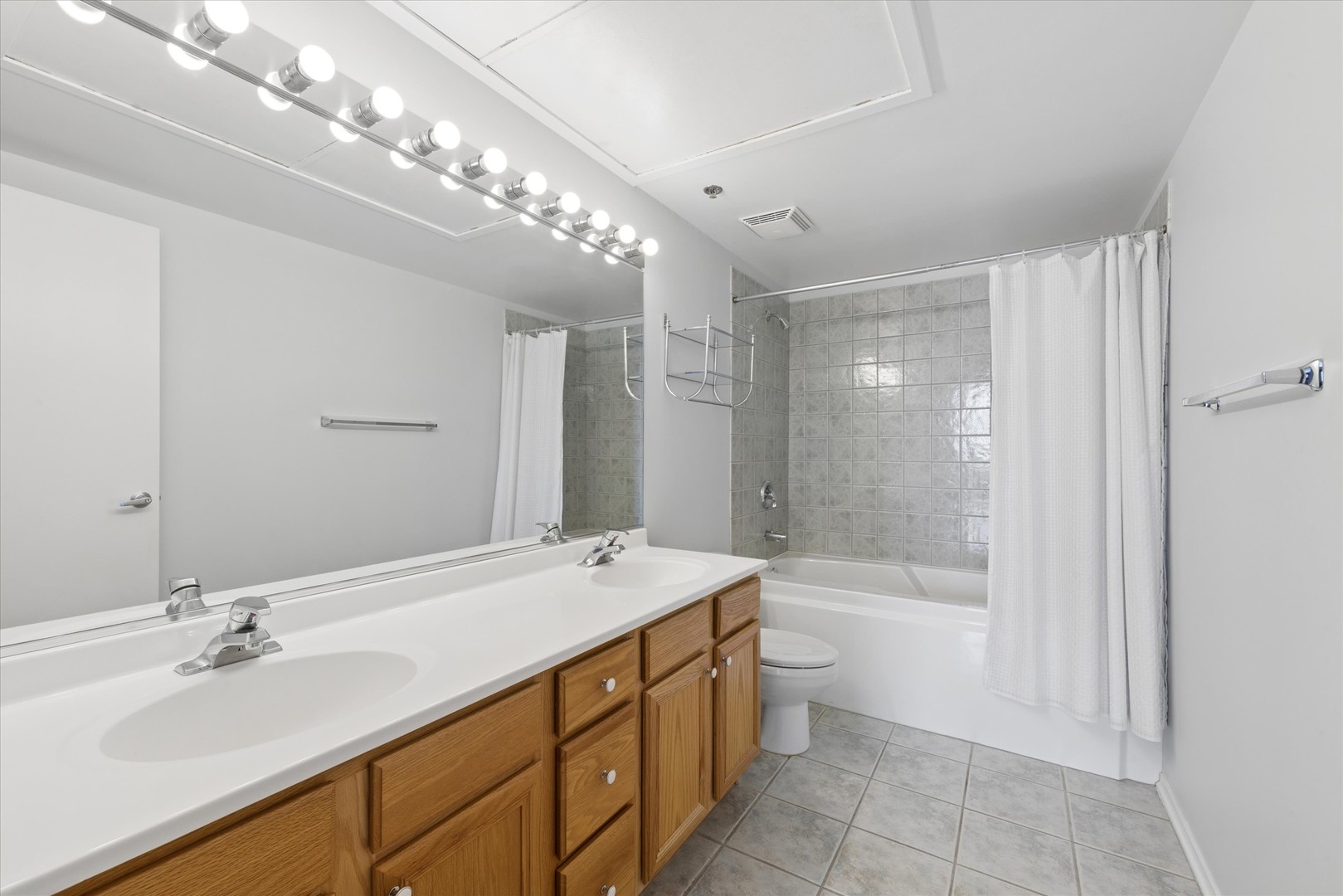 1530 South State Street, Unit 17R Chicago, IL 60605 - Photo 28 of 44 a bathroom with a bathtub shower sink vanity and toilet
