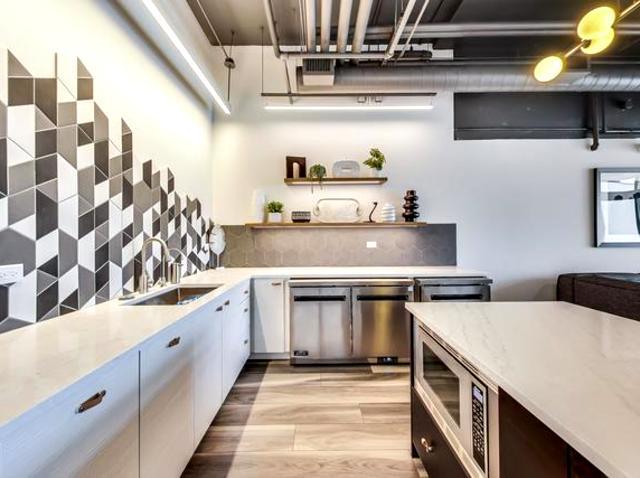 1530 South State Street, Unit 17R Chicago, IL 60605 - Photo 37 of 44 a kitchen with stainless steel appliances granite countertop a stove and a sink