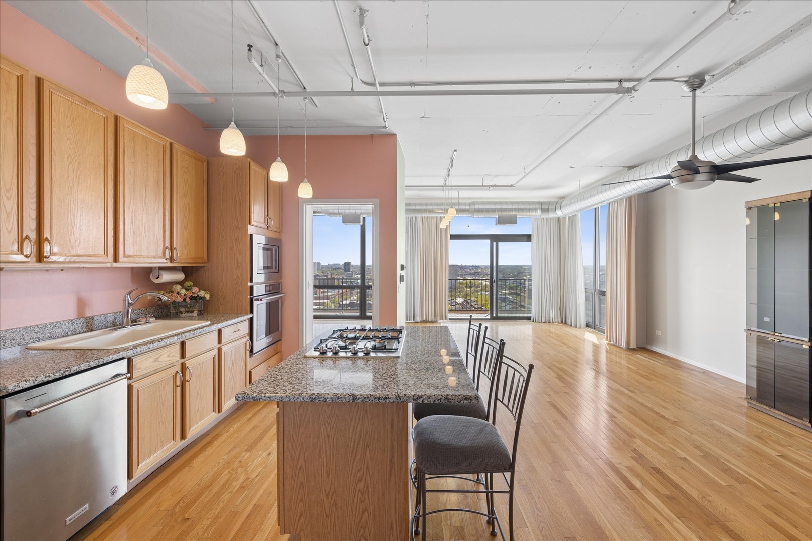 1530 South State Street, Unit 17R Chicago, IL 60605 - Photo 6 of 44 a large kitchen with kitchen island a large window a sink and cabinets