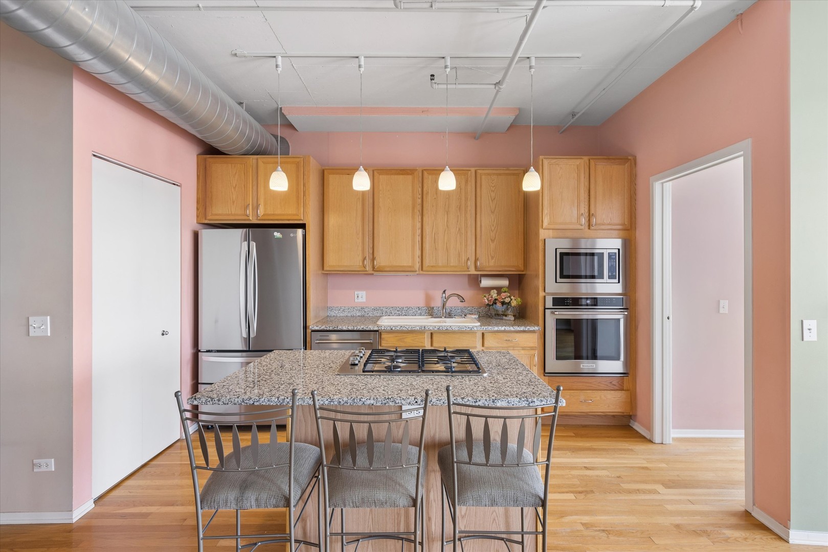 1530 South State Street, Unit 17R Chicago, IL 60605 - Photo 10 of 44 a kitchen with a table chairs refrigerator and cabinets